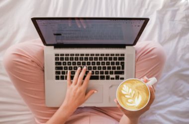 A person writing on a laptop